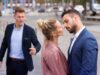 woman kissing man while another is upset